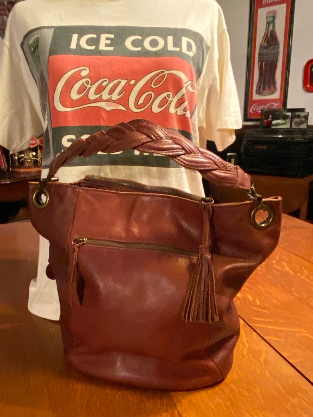 Lucky Brand leather bucket hobo bag. Leather tassel, antiqued brass logo charms.